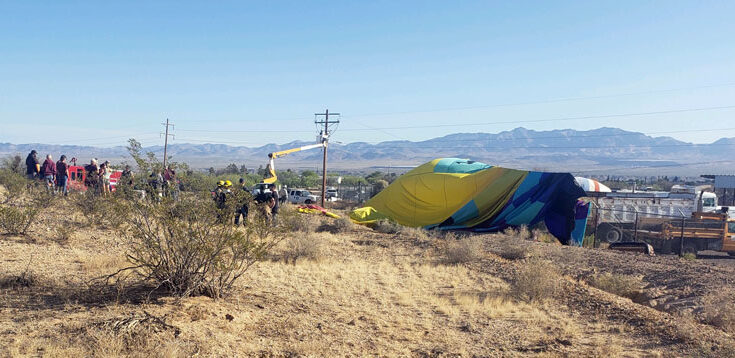 hot air balloon draped over utility wires