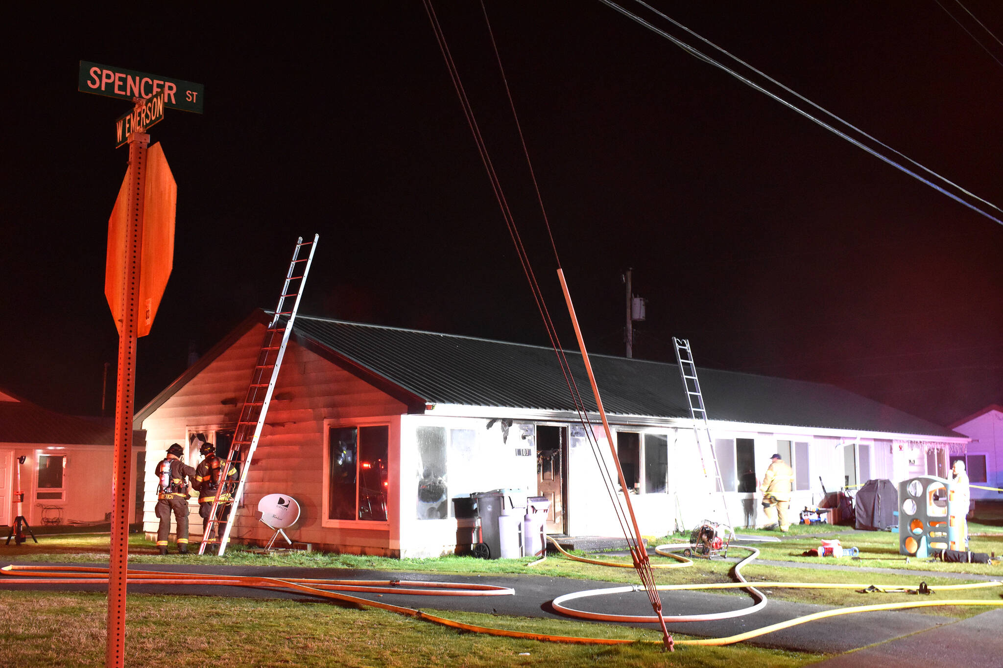 Home with fire equipment around it
